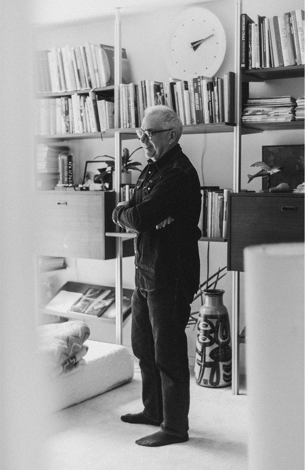 Jeff Farnsworth standing in front of his bookshelves