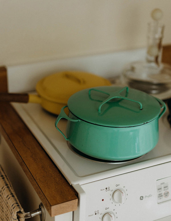 A turquoise pot on a stove