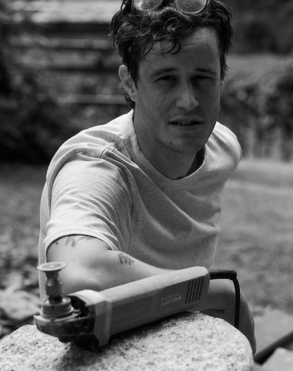 Matt Byrd posing next to stone carvings