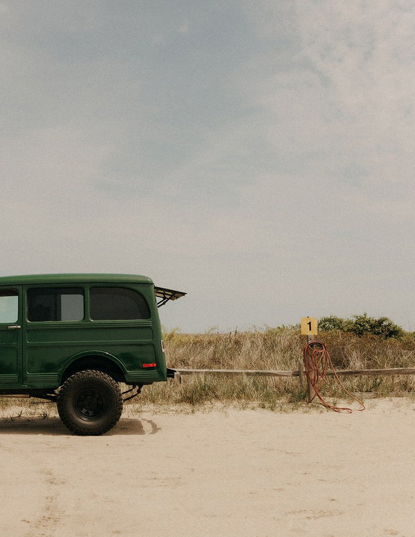 Vintage green jeep on the sand dunes
