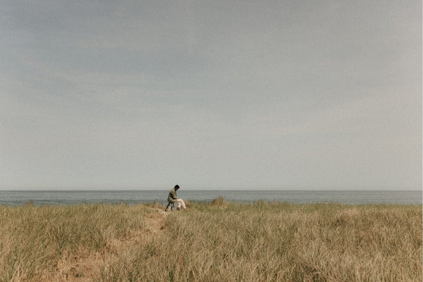 Model sitting on a stool in front of the ocean in Wellfleet