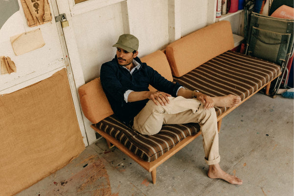 Model sitting on a mid-century couch at the Lechay House