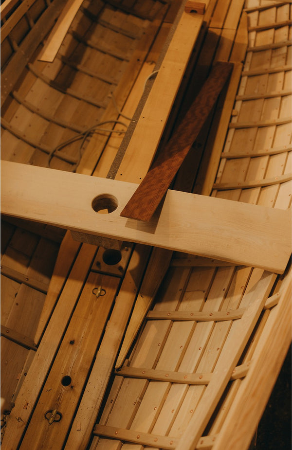 The exposed wooden hull of a boat in the process of being built