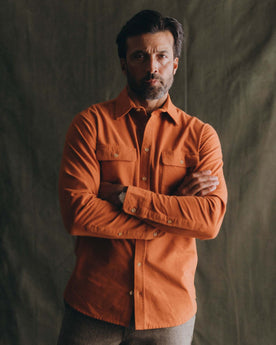 fit model posing in The Yosemite Shirt in Summit Orange, Wovens by Taylor Stitch