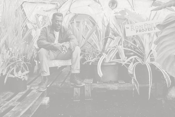 Ron sitting amongst the plants in his garden.