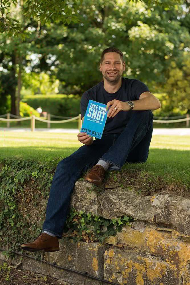 Robin holding a copy of his book