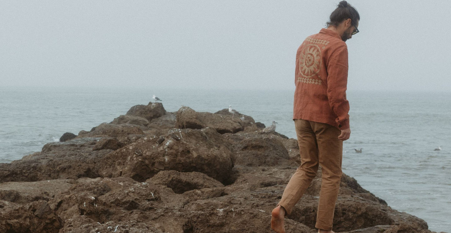 Daren Magee standing next to the sea in the Embroidered Ojai Jacket