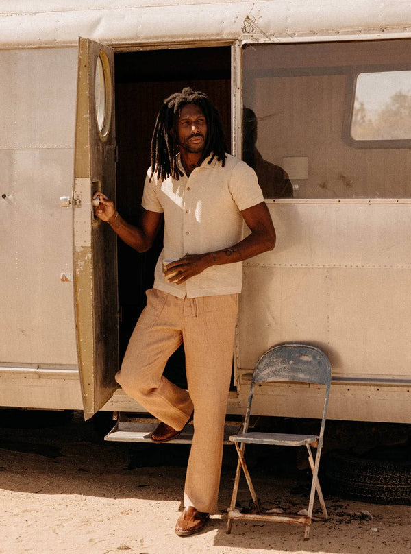 Model wearing The Button Down Polo in Heather Oat and The Breakwater Pant in Chili Stripe