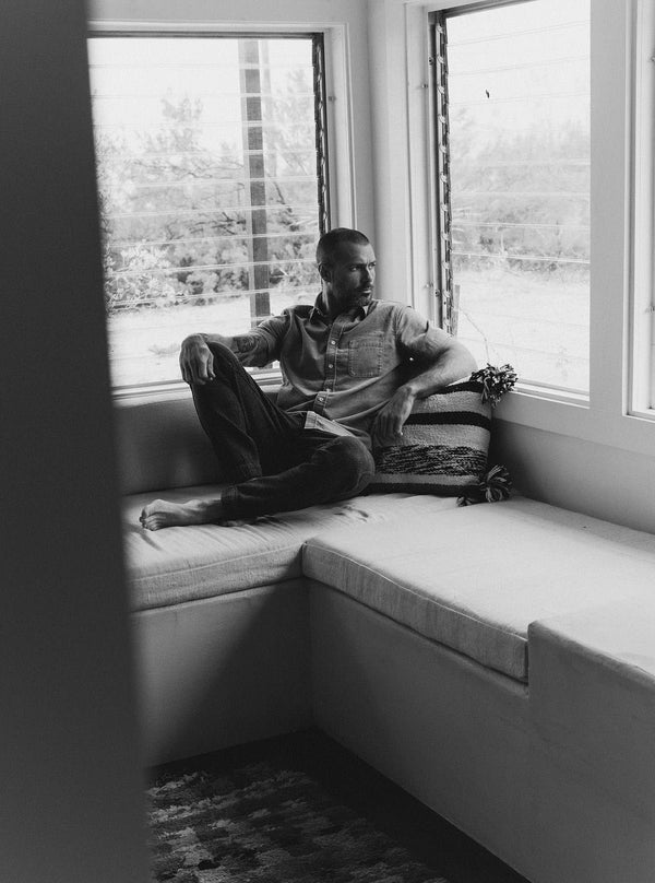 Model lounging in The Après Pant and The Short Sleeve California in Heather Moss Cord