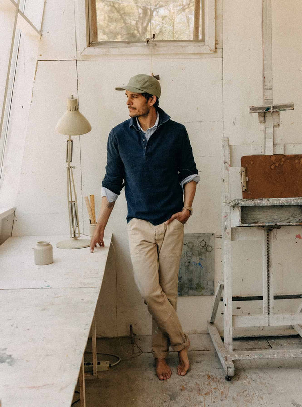 Model wearing The Long Sleeve Knit Polo in an art studio